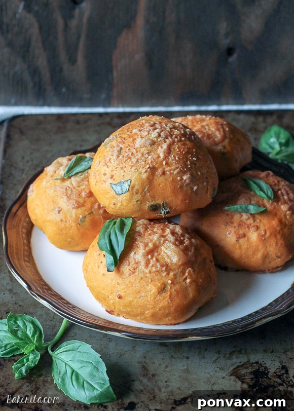 Discover the best Cheesy Tomato Basil Rolls: soft, savory bread infused with rich tomato and basil, encasing a melt-in-your-mouth mozzarella core, finished with a crisp Parmesan topping.