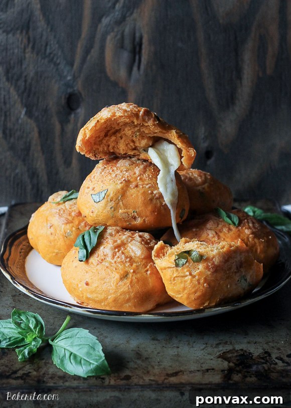 Enjoy the homemade goodness of Cheesy Tomato Basil Rolls, featuring a tender crumb, rich tomato and basil flavor, and a gooey mozzarella center. Perfect for any meal or snack.