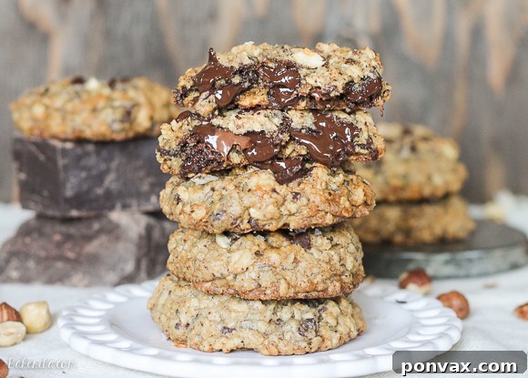 Close-up of a Nutella Stuffed Oatmeal Chocolate Chip Cookie, showing the rich dark chocolate and toasted hazelnuts.
