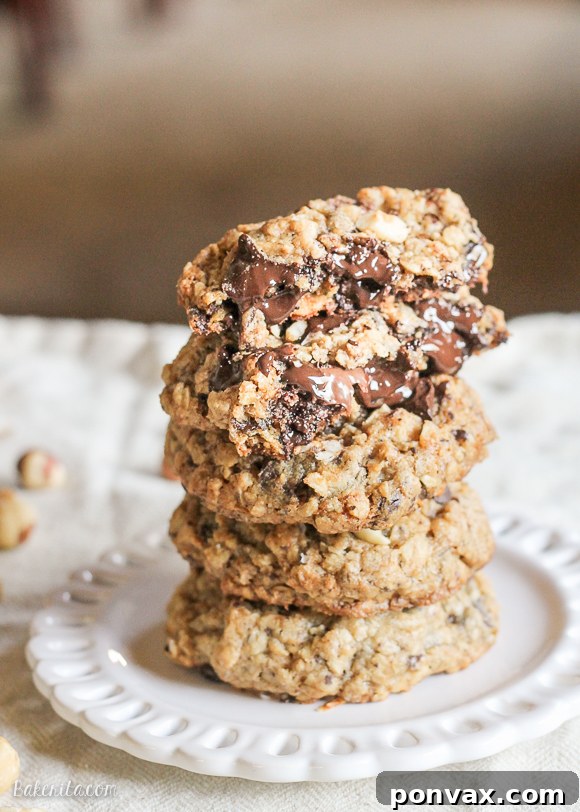 Stack of Nutella-Stuffed Oatmeal Hazelnut Chocolate Chip Cookies, highlighting the rich texture and delicious fillings.