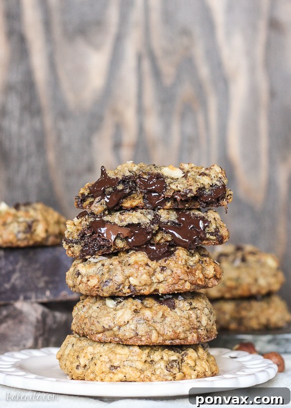 Nutella-Stuffed Oatmeal Chocolate Chip Cookies cooling on a wire rack, ready to be enjoyed.