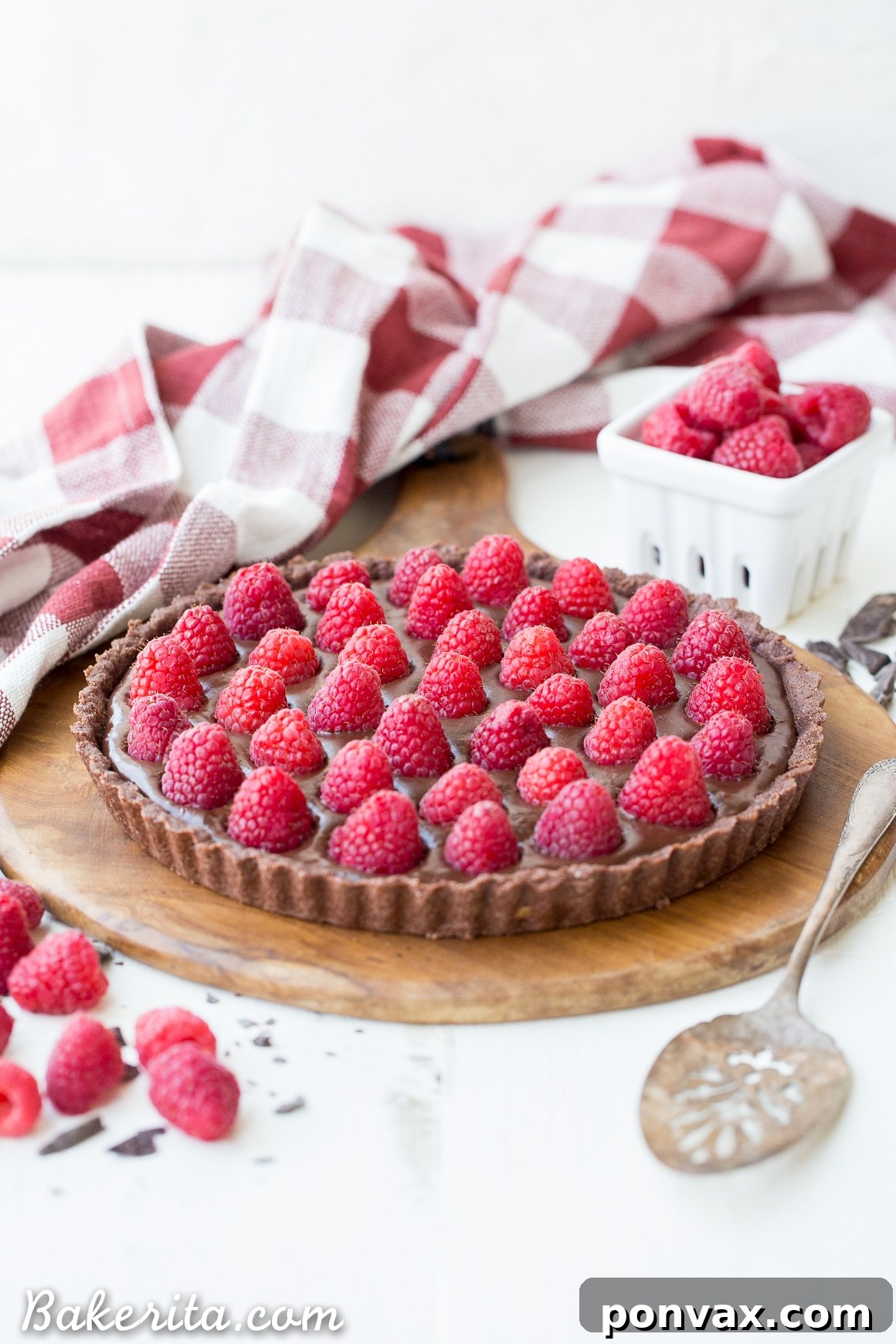 Silky Vegan No-Bake Raspberry Chocolate Tart 2 A stunning No-Bake Raspberry Chocolate Tart, featuring a rich chocolate crust, creamy ganache, and fresh raspberries, set against a bright backdrop.