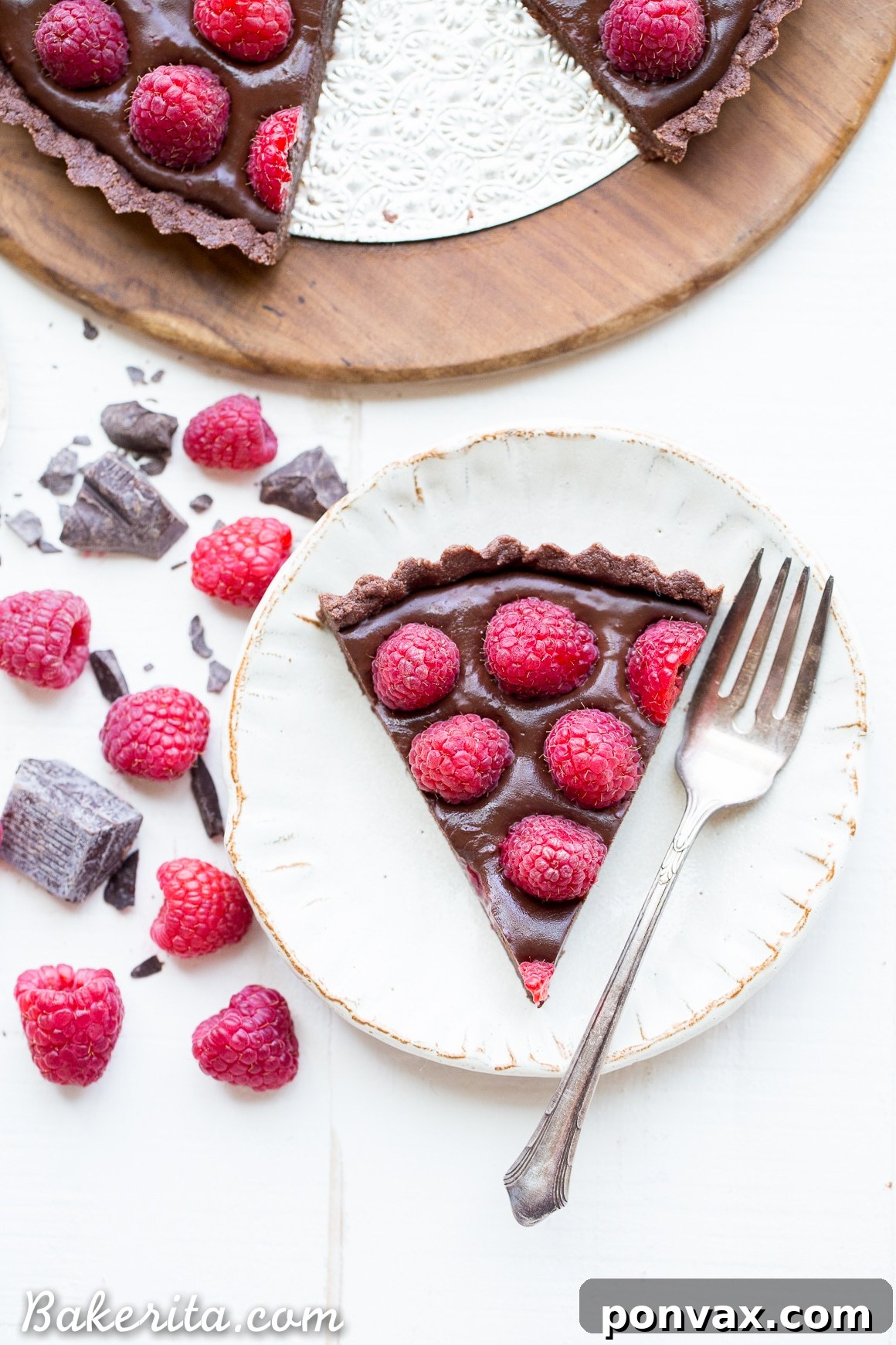 Silky Vegan No-Bake Raspberry Chocolate Tart 3 Close-up of the No-Bake Raspberry Chocolate Tart, highlighting the vibrant red raspberries contrasting with the dark chocolate filling and crust.