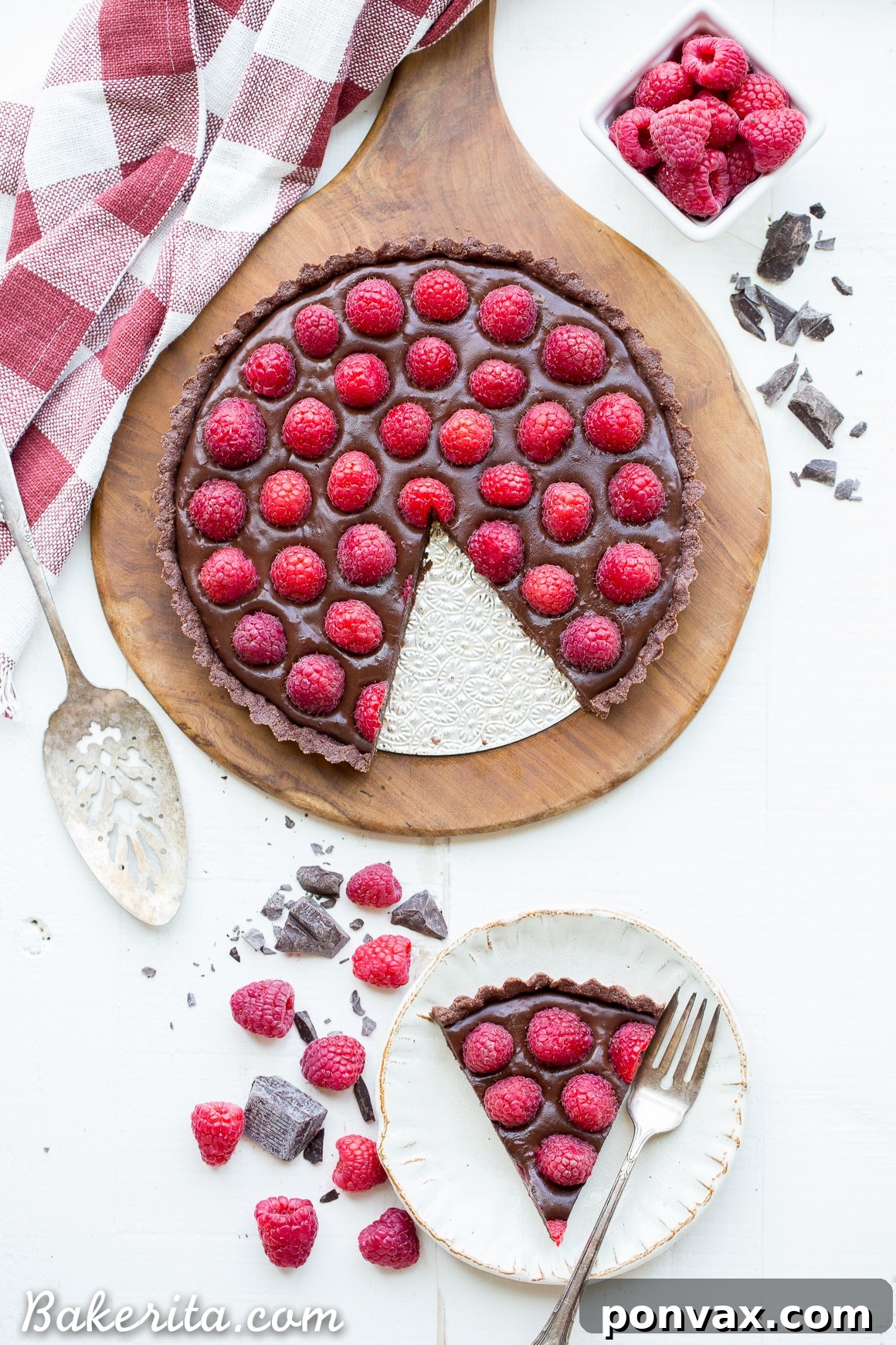Silky Vegan No-Bake Raspberry Chocolate Tart 5 A slice of the No-Bake Raspberry Chocolate Tart, revealing its distinct layers of chocolate crust, ganache, and whole fresh raspberries.