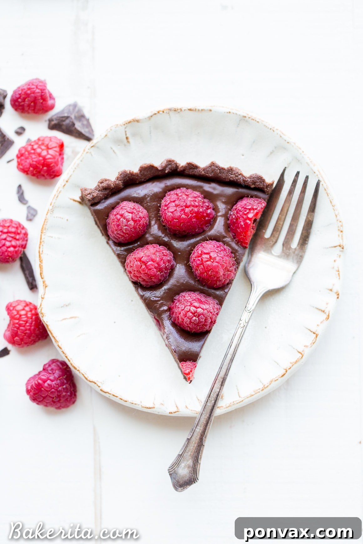 Silky Vegan No-Bake Raspberry Chocolate Tart 6 Another beautiful shot of the No-Bake Raspberry Chocolate Tart, emphasizing its glossy surface and abundant raspberry topping.