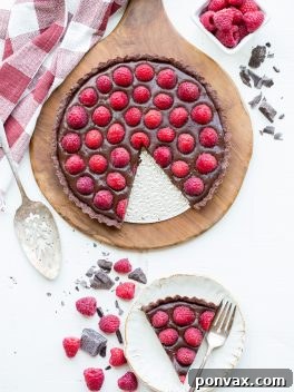 Silky Vegan No-Bake Raspberry Chocolate Tart 7 A beautiful No-Bake Raspberry Chocolate Tart, highlighting its rich layers and fresh berry topping.