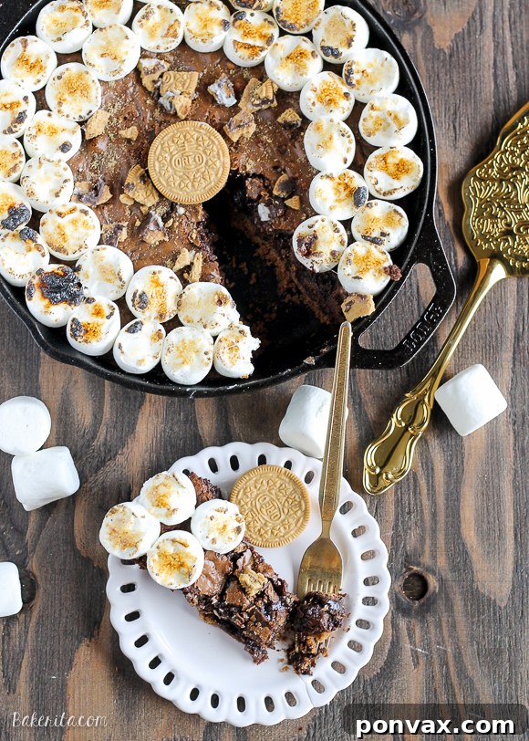Decadent S'mores Oreo Skillet Brownie 4 A side view of the S'mores Oreo Skillet Brownie, showing the distinct layers of crust, fudgy brownie, and toasted marshmallows.