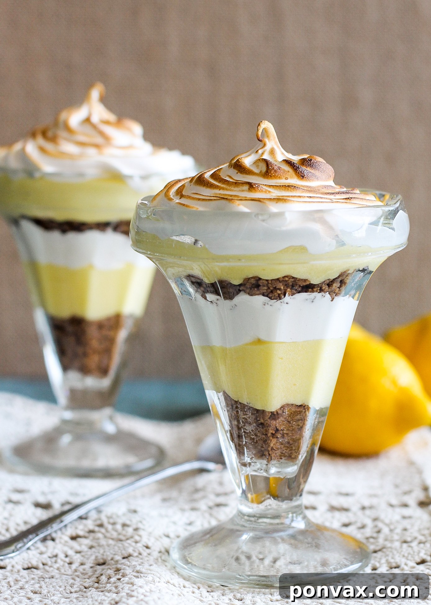 These Lemon Meringue Pie Parfaits are a no-bake dessert that will be your new summer favorite! Lemon curd, graham cracker crumbs, and meringue makes the best individual treats.