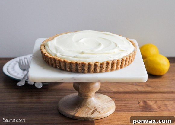 The creamy lemon filling being poured into the baked browned butter crust, showcasing its smooth and inviting texture.