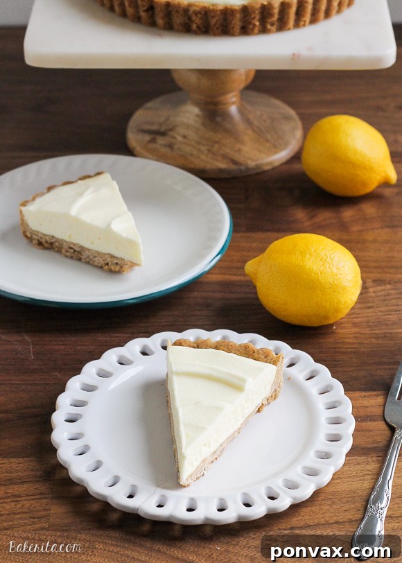 A beautifully presented Frozen Lemon Cream Tart, sliced and ready to serve, showing off its creamy filling and golden browned butter crust.