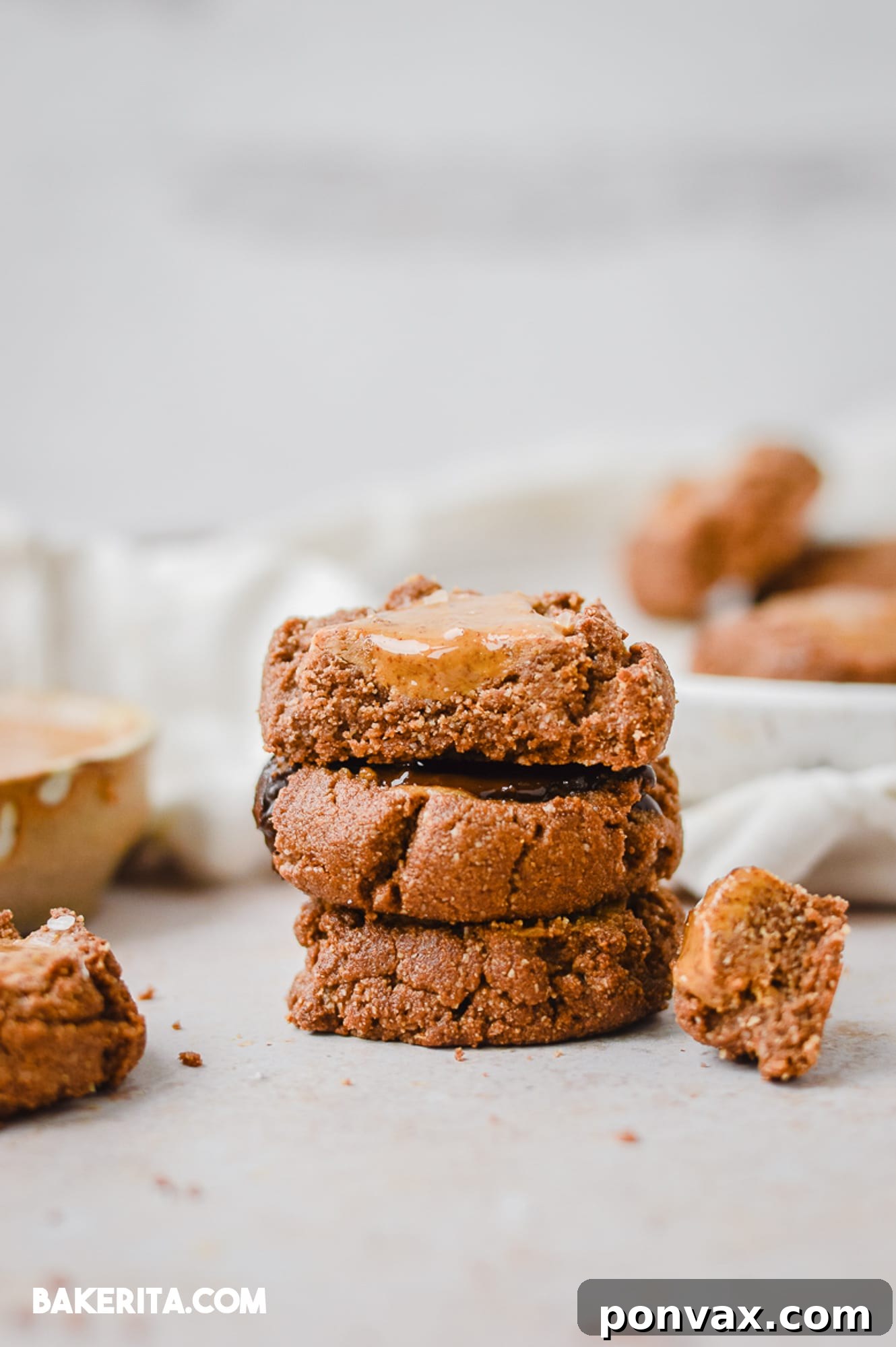 Close-up of baked chocolate almond butter thumbprint cookies, showcasing their chewy texture and rich filling.