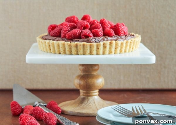 A rustic image of a hand picking sun-ripened raspberries directly from the bush, highlighting the freshness of the berries.