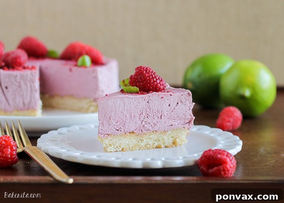 Close-up of the smooth, pink raspberry lime cheesecake filling, showcasing its creamy texture.