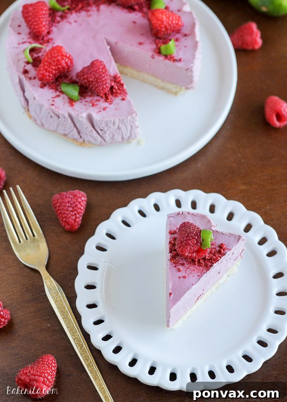 Another view of the whole Vegan Raspberry Lime Cheesecake with Coconut Crust, showcasing its beautiful presentation.