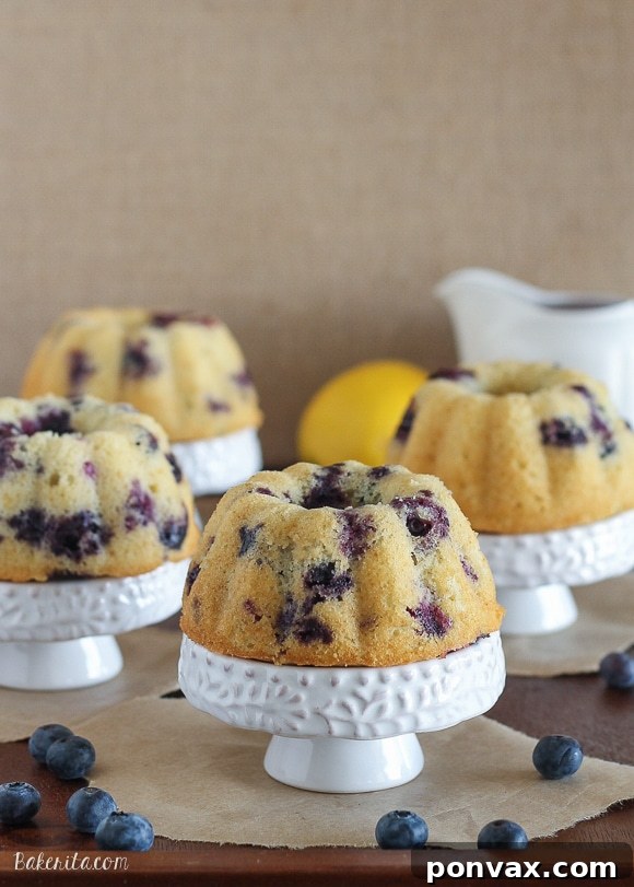 A selection of Mini Lemon Blueberry Bundt Cakes cooling on a wire rack, ready for glazing.