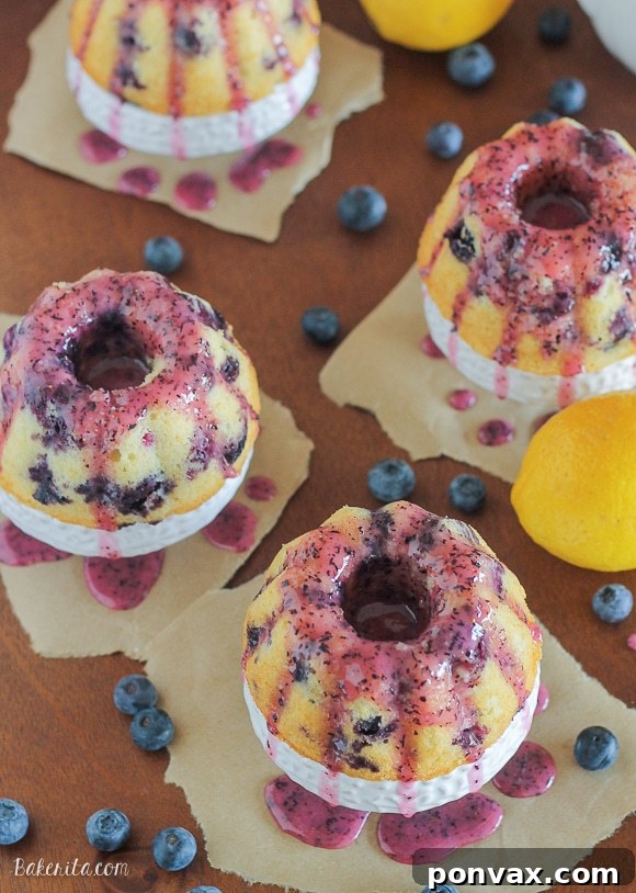 Mini Lemon Blueberry Bundt Cakes covered in a vibrant, fruity blueberry glaze.