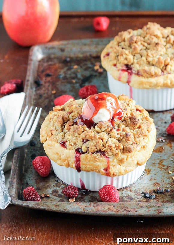 These Mini Apple Berry Crumble Pies are bursting with tart, juicy berries and tender apple slices, topped with a delectably crunchy crumble topping! Serve with ice cream for the best treat.