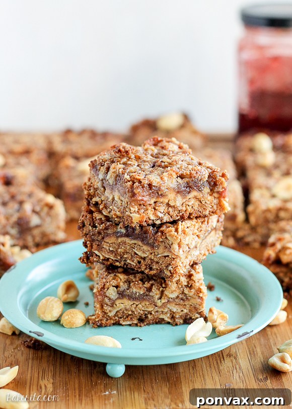 Delicious and healthy Peanut Butter & Jelly Crumb Bars with a thick PB&J layer and golden oatmeal crust, perfect for a gluten-free and vegan treat.