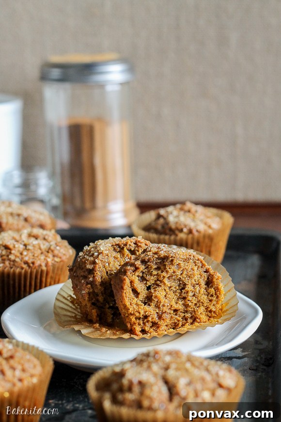 Close-up of a freshly baked Vegan Pumpkin Spice Latte Muffin, showcasing its tender crumb and inviting golden-brown top, dusted with turbinado sugar.