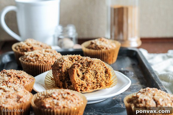 A full tray of warm Vegan Pumpkin Spice Latte Muffins cooling on a wire rack, sprinkled with turbinado sugar for a delightful crunch.