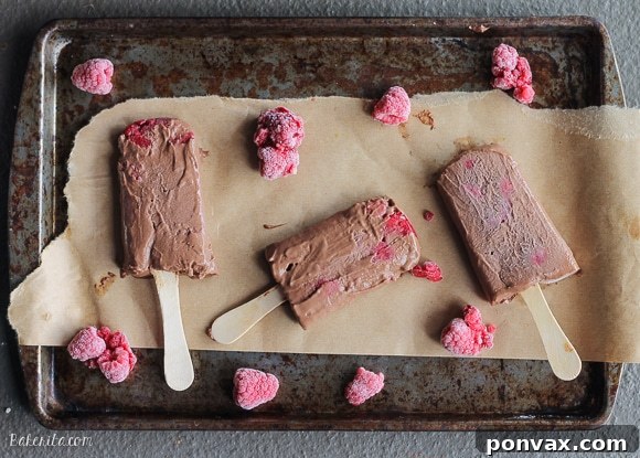 These Chocolate Raspberry Popsicles are a refreshing frozen chocolate treat to enjoy on a hot day. These pops, filled with raspberries, are also vegan!