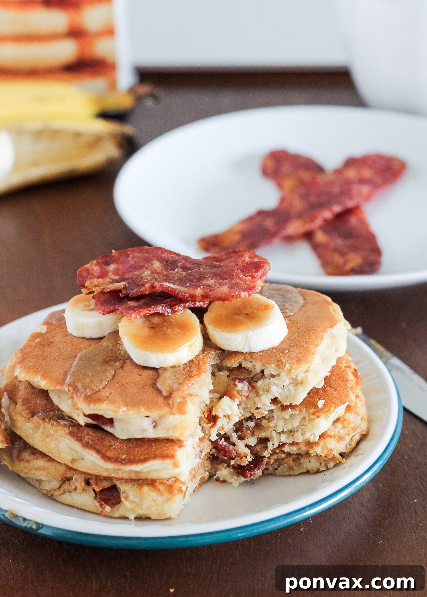 Delicious Elvis Pancakes, featuring banana peanut butter pancakes stuffed with creamy peanut butter and crispy bacon. The ultimate breakfast treat.