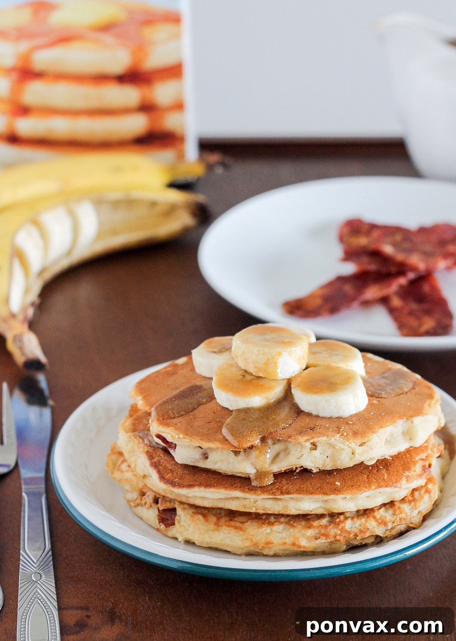 A stack of golden brown Elvis Pancakes, perfectly cooked and ready to be served, highlighting their inviting texture.