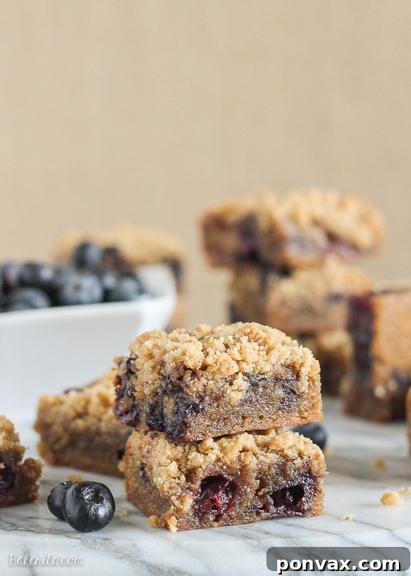 Close-up of freshly baked Blueberry Crumb Blondies with a golden crumb topping and visible blueberries