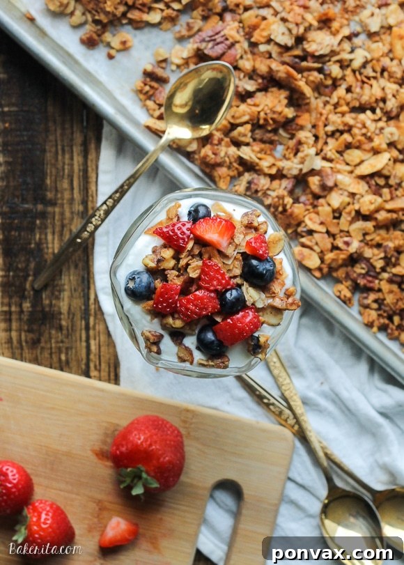 Hands carefully preparing and mixing ingredients for a batch of homemade Paleo Granola, emphasizing the mindful process of healthy baking.