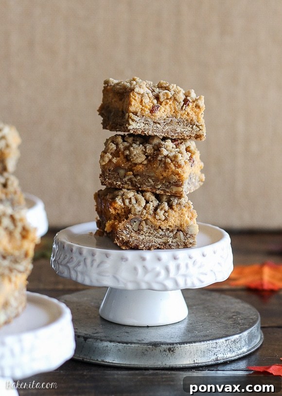 These Pumpkin Cheesecake Crumb Bars have a crumble crust full of oats and pecans with a creamy pumpkin cheesecake filling. This recipe is an irresistible fall treat!