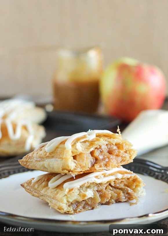 Golden brown homemade Caramel Apple Toaster Strudels drizzled with cream cheese glaze, a perfect fall treat.