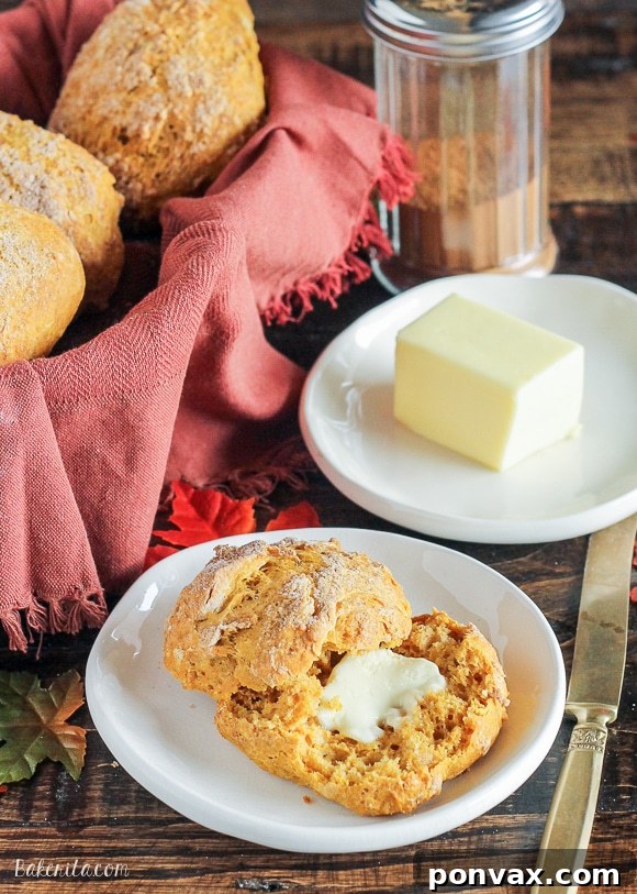 A warm, freshly baked Cinnamon Sugar Pumpkin Roll, torn open to reveal its soft, fluffy interior.