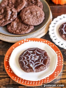 Ultimate Chocolate Spiderweb Cookies topped with white and dark chocolate ganache.