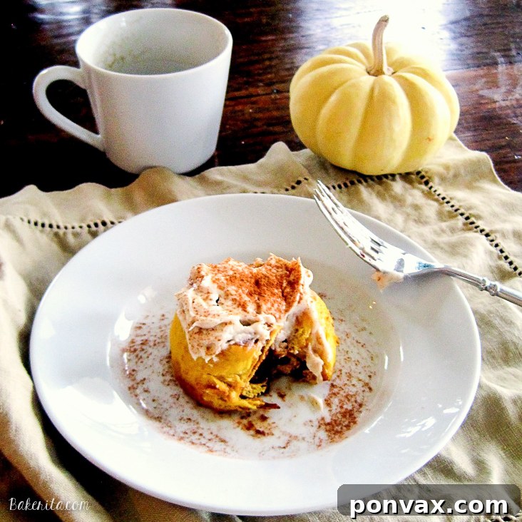 Delicious Pumpkin Cinnamon Rolls with cream cheese frosting, a perfect autumn treat.