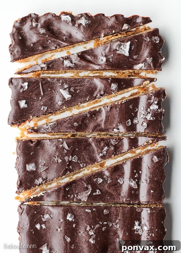 Close-up of a stack of elegant Brown Butter Shortbread cookies with dark chocolate and sea salt, ready to be enjoyed or gifted.